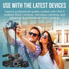 Promotional graphic for a PNY EliteX-PRO60 UHS-II 512GB SDXC, featuring a man and woman taking a selfie with a smartphone, a large video camera at the bottom left, and text reading 'USE WITH THE LATEST DEVICES' and 'Capture professional quality content with UHS-II enabled DSLR cameras, mirrorless cameras, and advanced & professional video cameras.'.